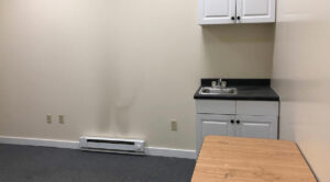 600 SF Office for lease in Allentown featuring an empty room with a sink and a refrigerator.