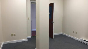 An empty room with a door and a doorway available for lease in Allentown