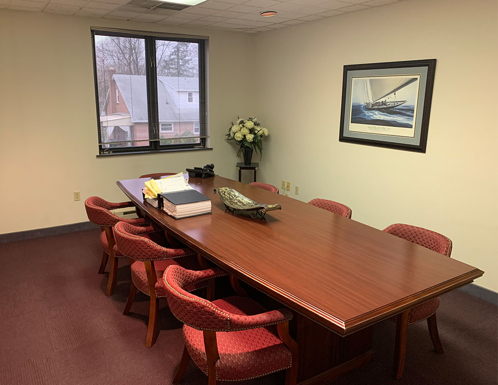 An office conference room with a grand table and chairs